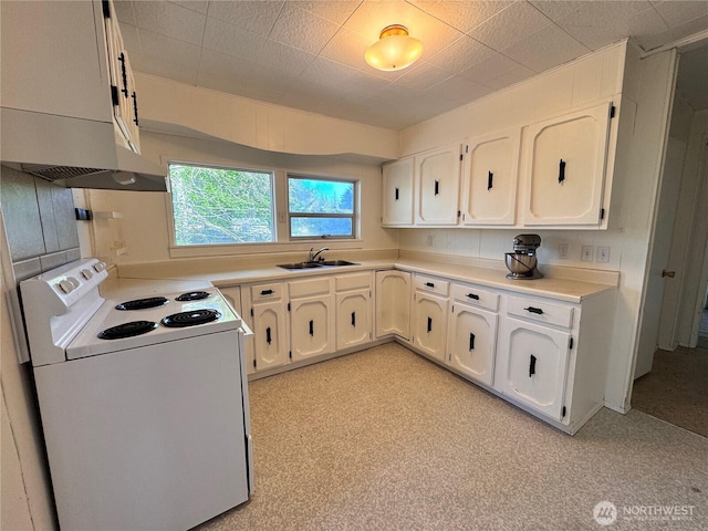 kitchen with light countertops, white cabinetry, a sink, and white range with electric stovetop