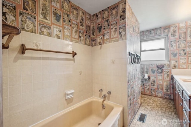 bathroom featuring tub / shower combination, vanity, wallpapered walls, and visible vents