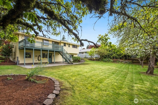 exterior space with a fenced backyard, a wooden deck, stairway, and a patio
