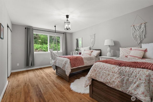 bedroom featuring baseboards and wood finished floors