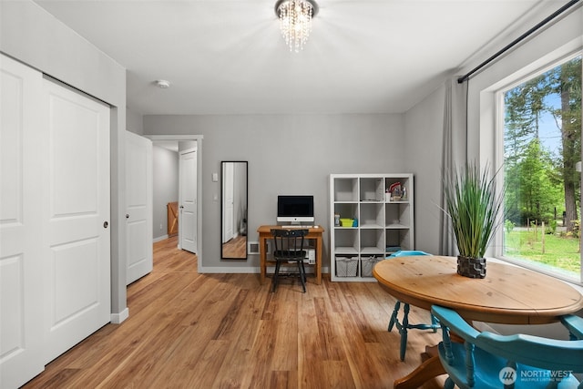 interior space featuring light wood-style floors and a notable chandelier