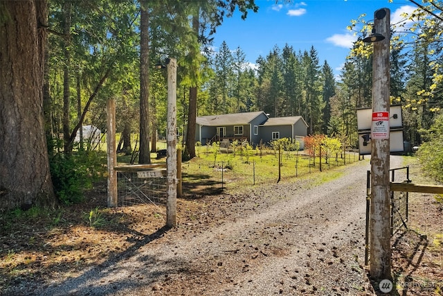 view of street with dirt driveway