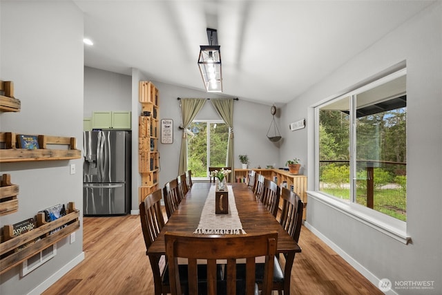 dining area with baseboards and light wood-type flooring