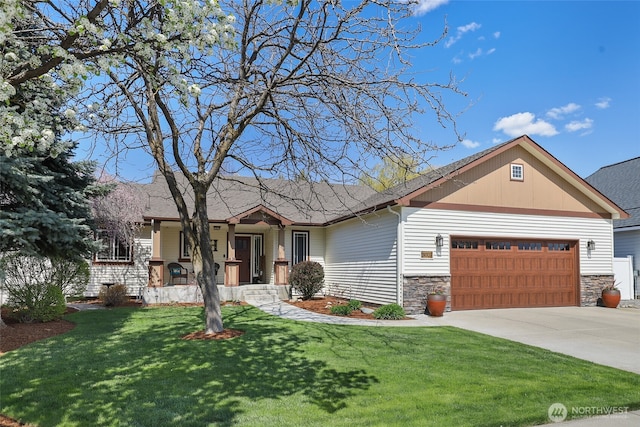 view of front of house featuring concrete driveway, a front lawn, stone siding, and a garage