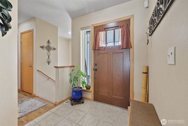 foyer entrance featuring visible vents