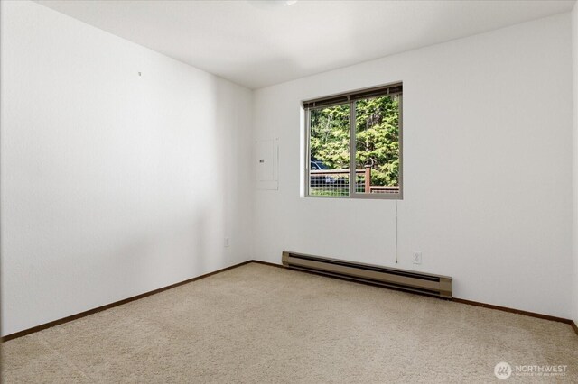 unfurnished room featuring baseboards, a baseboard radiator, and carpet flooring