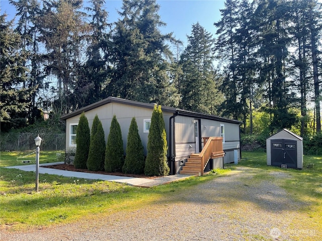 611 Cedar Ave Unit 33, Port Hadlock, WA 98339 - manufactured / mobile home with an outdoor structure, a storage shed, and a front lawn