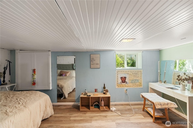 bedroom with wood finished floors and wood ceiling