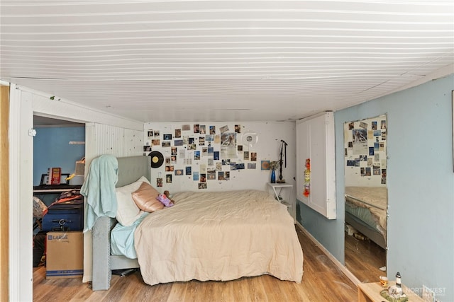 bedroom featuring wood finished floors