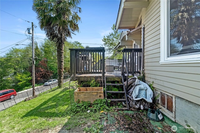 view of yard with a wooden deck and fence