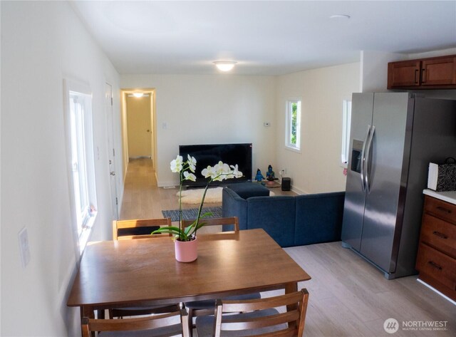 dining area featuring light wood-style flooring