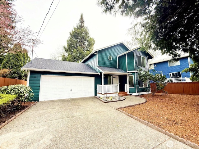 view of front facade with driveway, an attached garage, covered porch, and fence