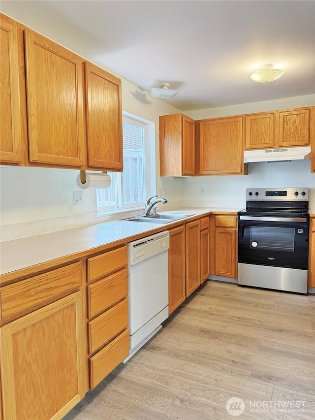 kitchen with a sink, under cabinet range hood, light countertops, dishwasher, and electric range