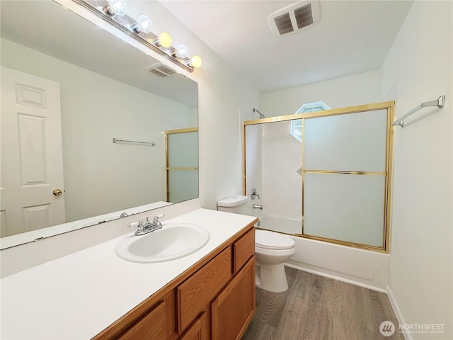 bathroom featuring wood finished floors, visible vents, toilet, and vanity