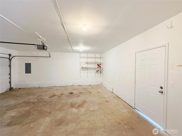 garage with a garage door opener and electric panel