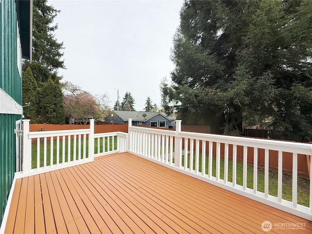 deck with a lawn and a fenced backyard