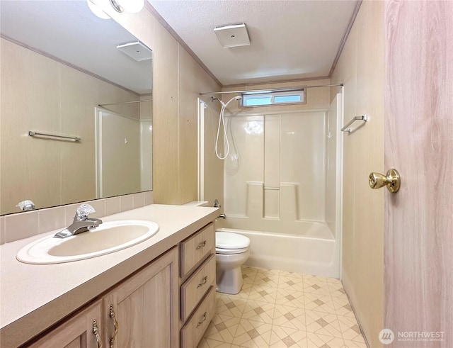 bathroom with vanity, crown molding, toilet, and shower / bathtub combination