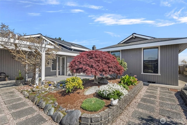 view of front of property featuring solar panels