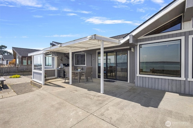 back of property with a patio area, fence, and outdoor dining space
