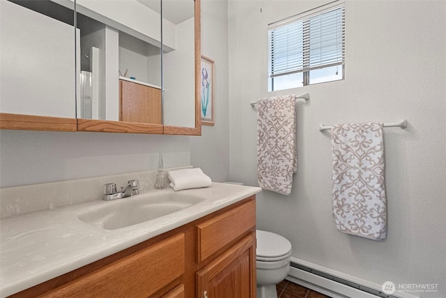bathroom featuring vanity, tile patterned flooring, baseboard heating, and toilet