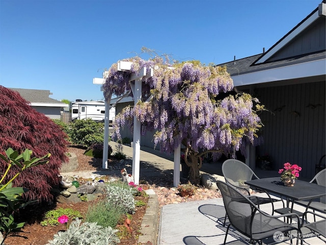view of patio featuring fence and outdoor dining space