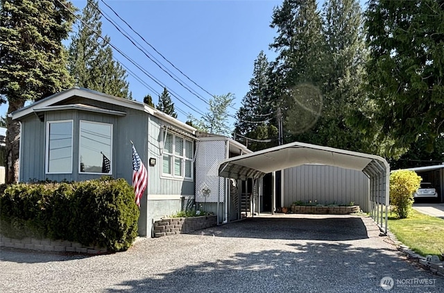 view of front of house featuring a detached carport and driveway