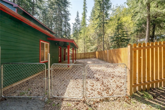 exterior space with fence private yard and a gate