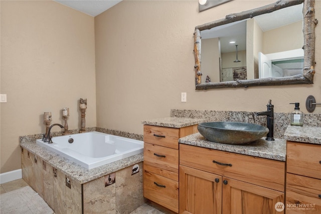 full bathroom with vanity, tile patterned floors, and a bath