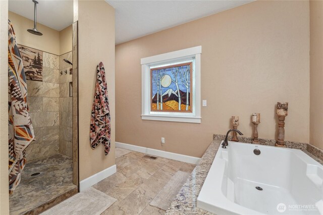 bathroom with a bath, visible vents, baseboards, marble finish floor, and tiled shower