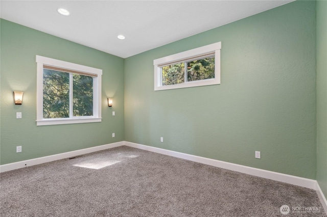 unfurnished room with carpet flooring, recessed lighting, baseboards, and visible vents
