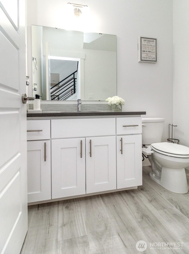 6318 230th Avenue Ct E, Buckley, WA 98321 - bathroom with wood finished floors, toilet, and vanity