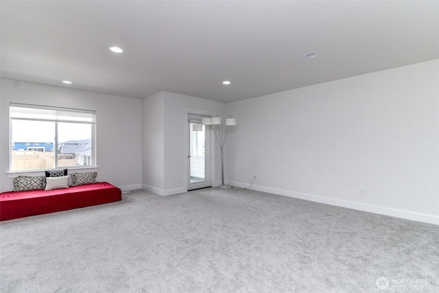 6318 230th Avenue Ct E, Buckley, WA 98321 - living area with baseboards, recessed lighting, light colored carpet, and a healthy amount of sunlight
