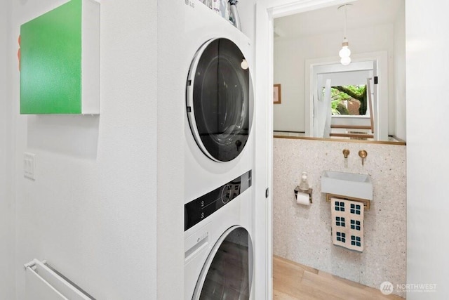 2305 E Alder St, Seattle, WA 98122 - clothes washing area with stacked washer and clothes dryer, wood finished floors, and laundry area