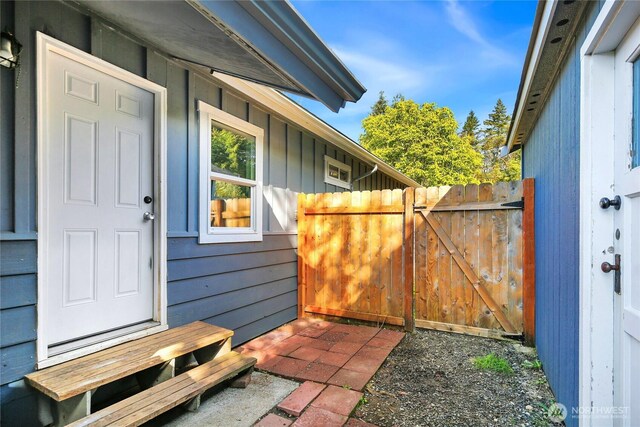 240 Willow St, Bremerton, WA 98310 - doorway to property featuring board and batten siding, fence, and a gate