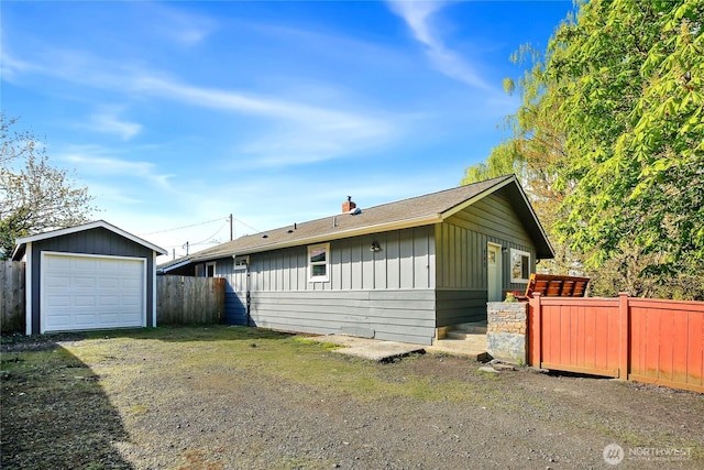 240 Willow St, Bremerton, WA 98310 - exterior space with a chimney, driveway, board and batten siding, fence, and an outbuilding