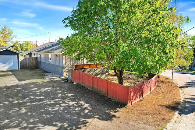 240 Willow St, Bremerton, WA 98310 - view of home's exterior with a garage, driveway, an outbuilding, and fence
