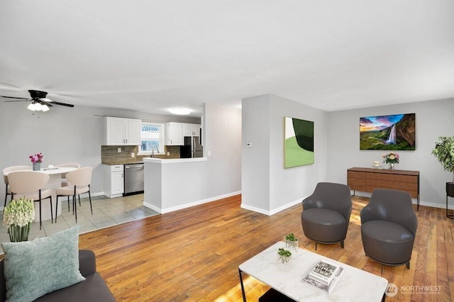 240 Willow St, Bremerton, WA 98310 - living room with baseboards, light wood-style floors, and ceiling fan