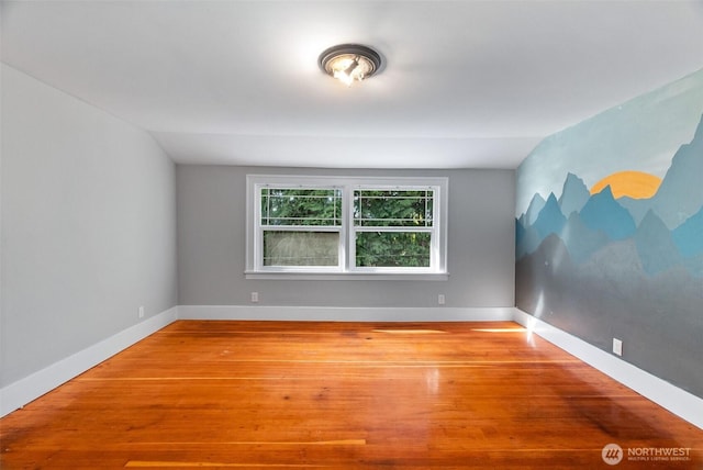 1812 N Pearl St, Centralia, WA 98531 - empty room with wood finished floors, lofted ceiling, and baseboards