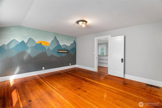 1812 N Pearl St, Centralia, WA 98531 - spare room featuring vaulted ceiling, baseboards, wood finished floors, and visible vents