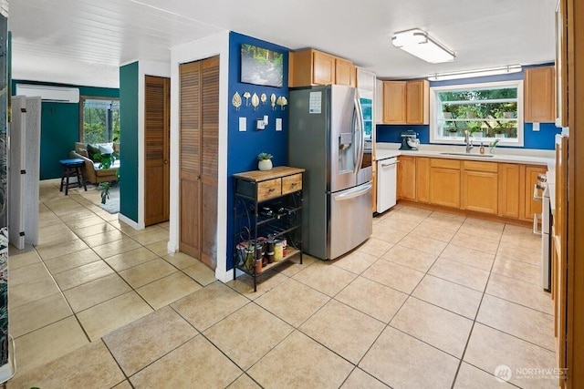 kitchen featuring white dishwasher, a sink, stainless steel fridge with ice dispenser, light countertops, and light tile patterned floors