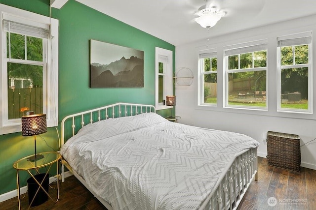 bedroom with baseboards and hardwood / wood-style floors