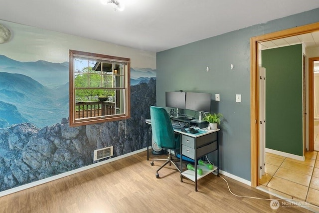 office space with visible vents, baseboards, and wood finished floors