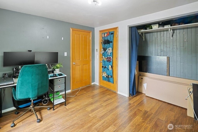 office featuring baseboards and wood finished floors
