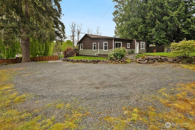 view of front of home featuring fence