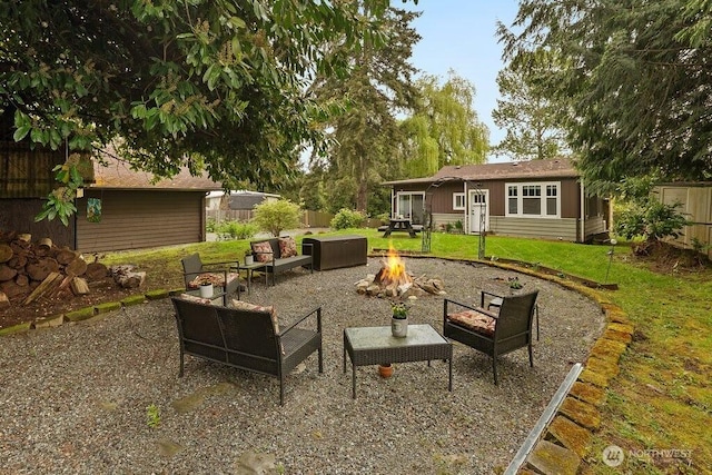 view of patio / terrace with an outdoor living space with a fire pit and fence