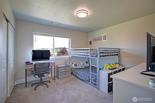 bedroom with a closet, carpet flooring, and visible vents