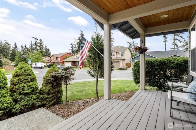 wooden deck with a yard and a residential view