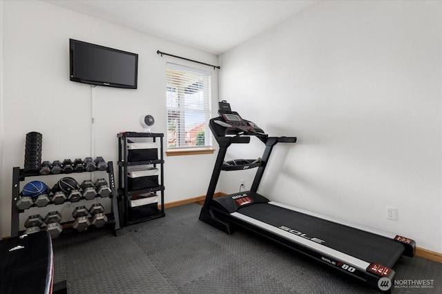 workout room with carpet floors and baseboards