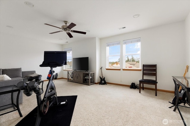 exercise area with carpet floors, baseboards, ceiling fan, and visible vents
