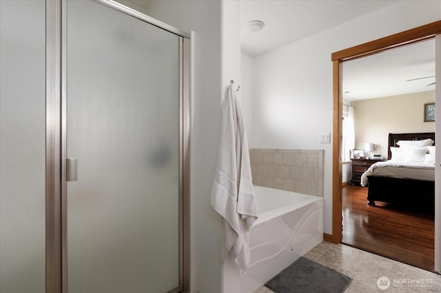 bathroom with tile patterned flooring, a stall shower, a bath, and ensuite bath